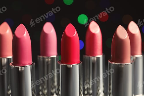 Preview: Different lipsticks against blurred lights. Cosmetic product