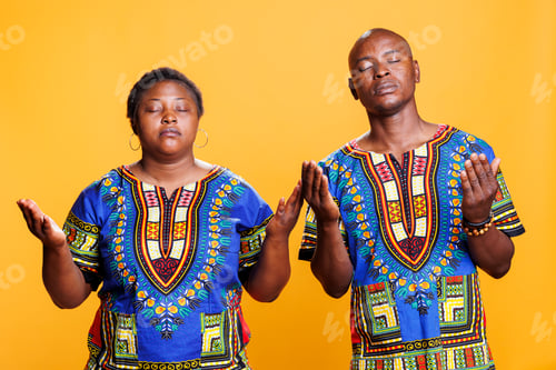 Preview: Black couple praying with spread arms