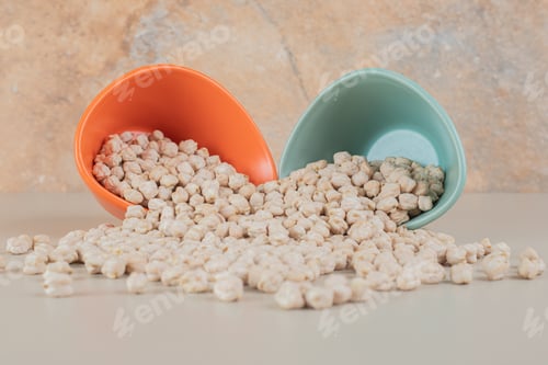 Preview: Raw white pea beans in a colorful cup on concrete background