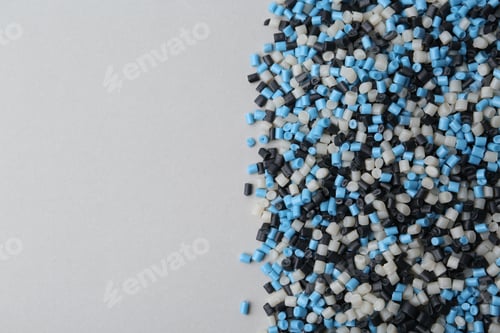 Preview: Pile of colorful plastic granules on grey background, top view. Space for text