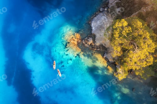 Preview: Aerial view of people on floating sup boards on blue sea