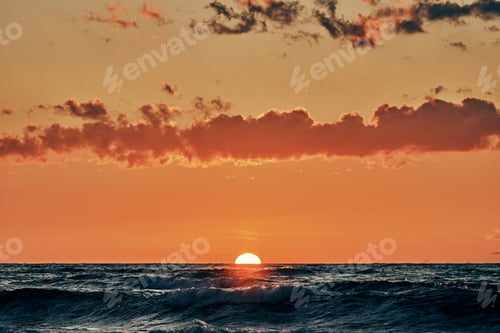 Preview: Half sun below horizon over blue sea waves, beautiful sunset over sea, breathtaking seascape