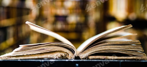 Preview: old open book in a library