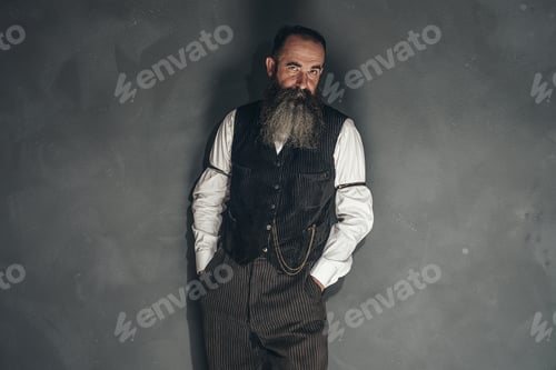 Preview: Vintage Beard Man In 1900 Style Fashion Against Grey Wall.