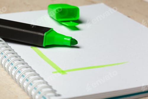 Preview: Green highlighter on notepad with drawn green color mark close up