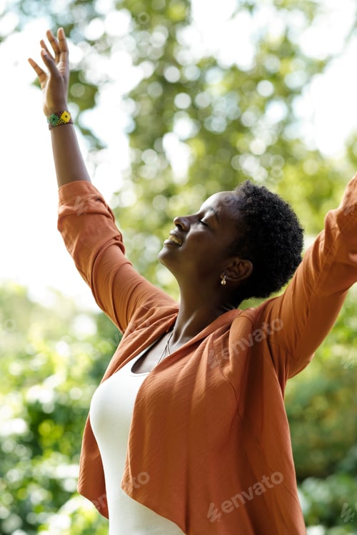 Preview: Black woman in arms-up in peace gesture.