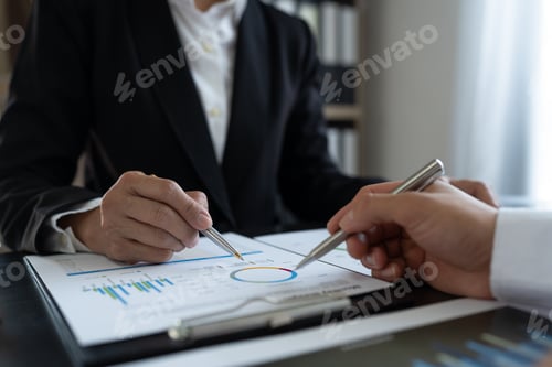 Preview: Team of business people working with calculator to calculate financial figures and analyzing sales d