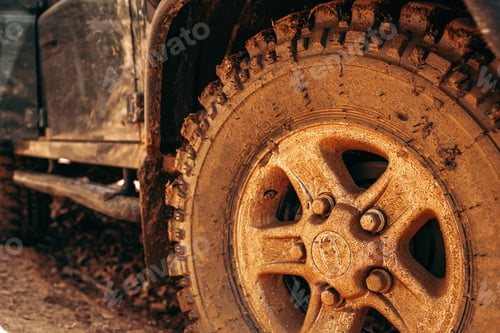 Preview: Wheel of offroad car in a muddy roadn forest