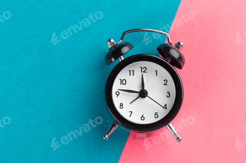 Preview: Vintage black alarm clock on a color block background