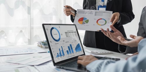 Preview: Business People Meeting using laptop computer,calculator,notebook,stock market chart paper for