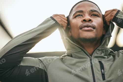 Preview: Exercise, mindset and hoodie with a sports black man getting ready for a workout, fitness or runnin