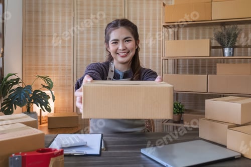 Preview: Smiling Woman Holding Box in Shipping Workplace
