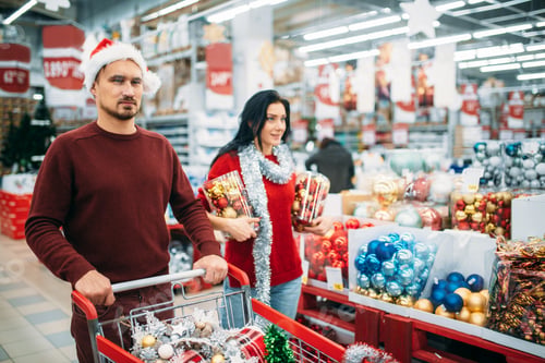 Preview: Young couple buying a lot of Christmas decorations