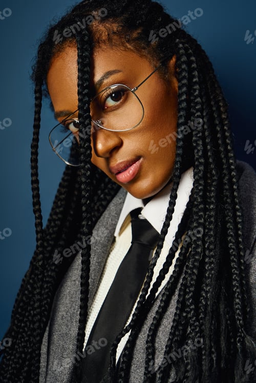 Preview: A beautiful young woman with braids is posing confidently, showcasing her unique style and charisma.