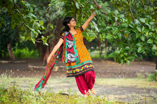 Preview: Beautiful girl between nature full of branches of tree.