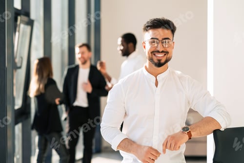 Preview: Handsome business man of indian appearance in white shirt in office