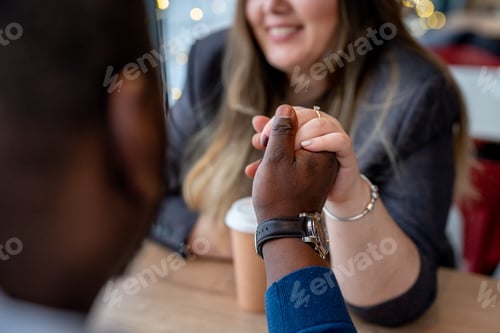 Preview: Happy diverse couple. Beautiful smiling woman with a man drinking coffee in a cafe.