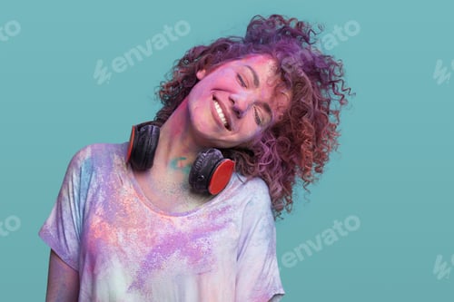 Preview: Happy young woman covered with colorful paint