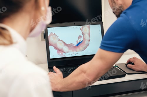 Preview: Dentist showing teeth scan to colleague