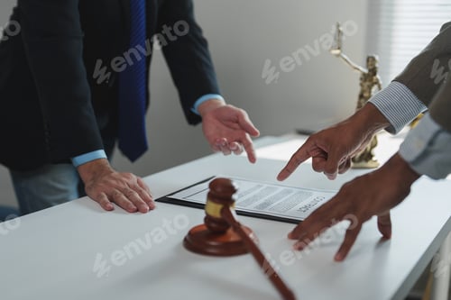 Preview: Lawyers discussing contract details with gavel and statue of justice