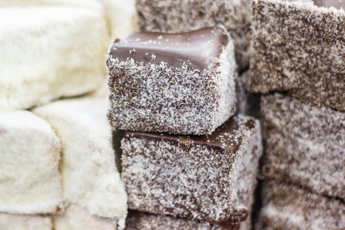 Preview: Pieces of fresh baked cake with icing, chocolate and desiccated coconut