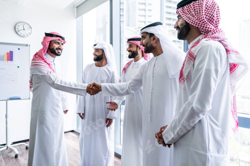 Preview: Arab businessmen wearing emirati and saudi kandura meeting in office
