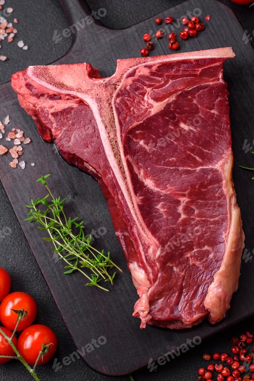 Preview: Raw juicy beef t-bone steak with salt, spices and herbs