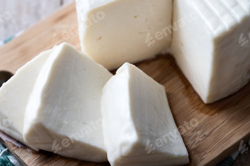 Preview: Sliced fresh white cheese from cow's milk on white background