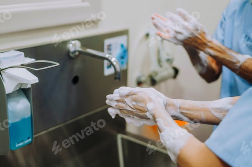 Preview: Unrecognizable doctor washing hands before operating
