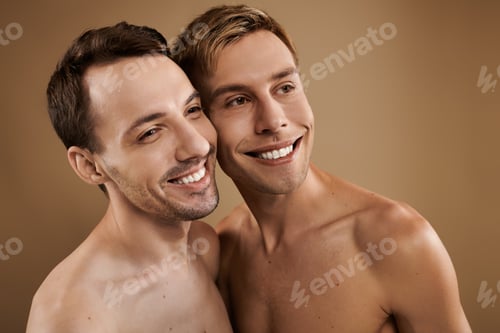 Preview: A joyful moment shared by a young gay couple celebrating their love and connection indoors