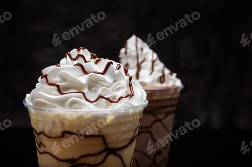 Preview: Vanilla milkshake with chocolate syrup in clear glass on dark background