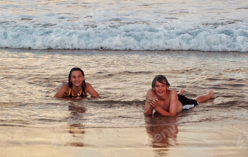 Preview: Children Playing in Ocean Water at Sunset