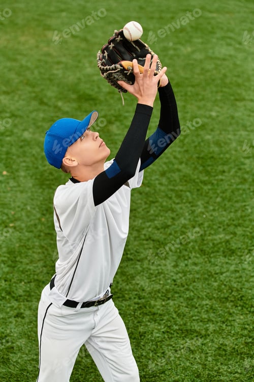 Preview: Young athlete catches baseball during practice on sunny field in summer