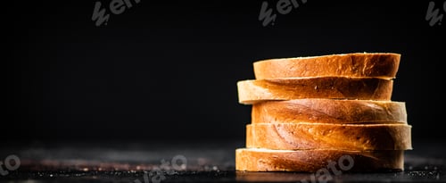Preview: Sliced wheat bread. On a black background.