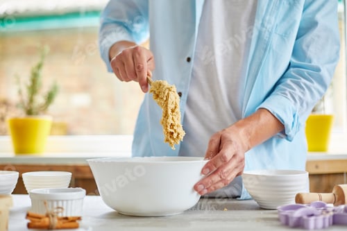 Preview: Man, male forming the dough in Bowl a and kneading at home