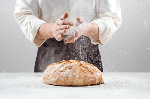 Preview: The male hands in flour and rustic organic loaf of bread