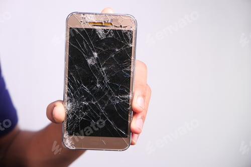 Preview: Close up of man hand holding broken smart phone.