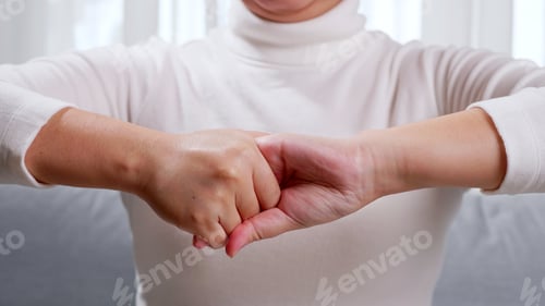 Preview: Close up of young woman hands, doing hand massage by herself for soothing and relaxing