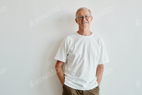 Preview: Senior Man Smiles Against a White Wall