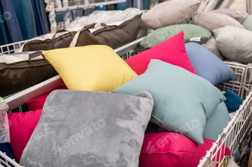 Preview: Colorful pillows in a textile basket for comfort and leisure at the store