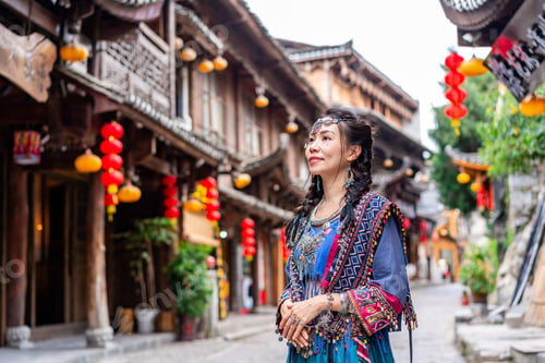 Preview: Young female tourist in traditional dress walking at Furong old Town