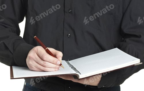 Preview: Man Writes in Notebook with Pen in Hand