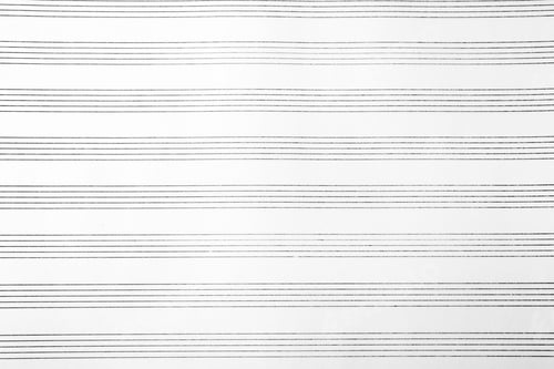 Preview: Paper with empty staves for music notes as background, top view