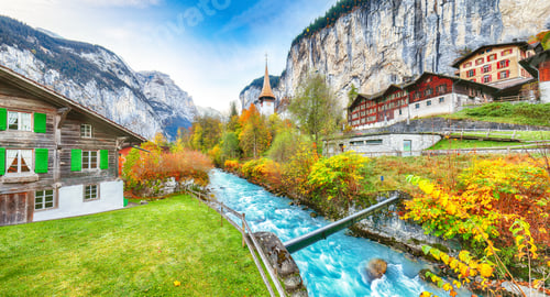 Preview: Stunning autumn view of Lauterbrunnen village with awesome waterfall Staubbach and Swiss Alps