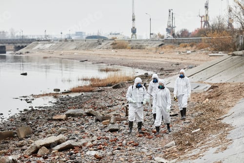 Preview: Group of Workers in Hazmat Suits at Industrial Disaster Site
