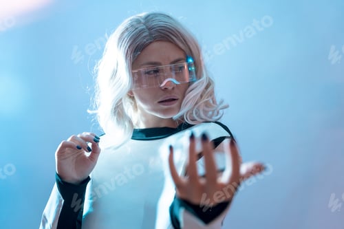 Preview: Woman with the illuminated futuristic glasses white hair, virtual reality with looking to the sides