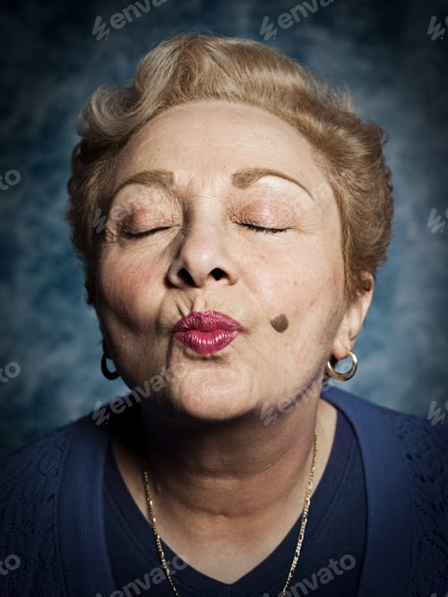 Preview: Senior woman blowing kiss, eyes closed