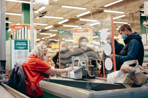 Preview: Man in protective medical mask buying groceries during quarantine, lockdown, coronavirus pandemic.