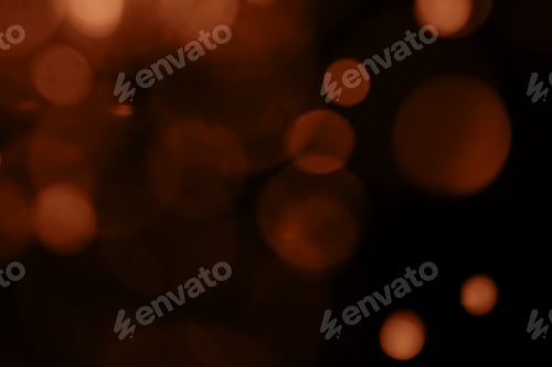 Preview: Blurry garland lights on a dark background. Image toned in color of the year 2024 - Peach Fuzz