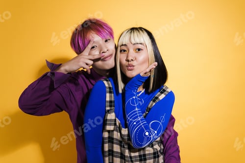 Preview: Asian couple with multicolored hair laughing and gesturing together